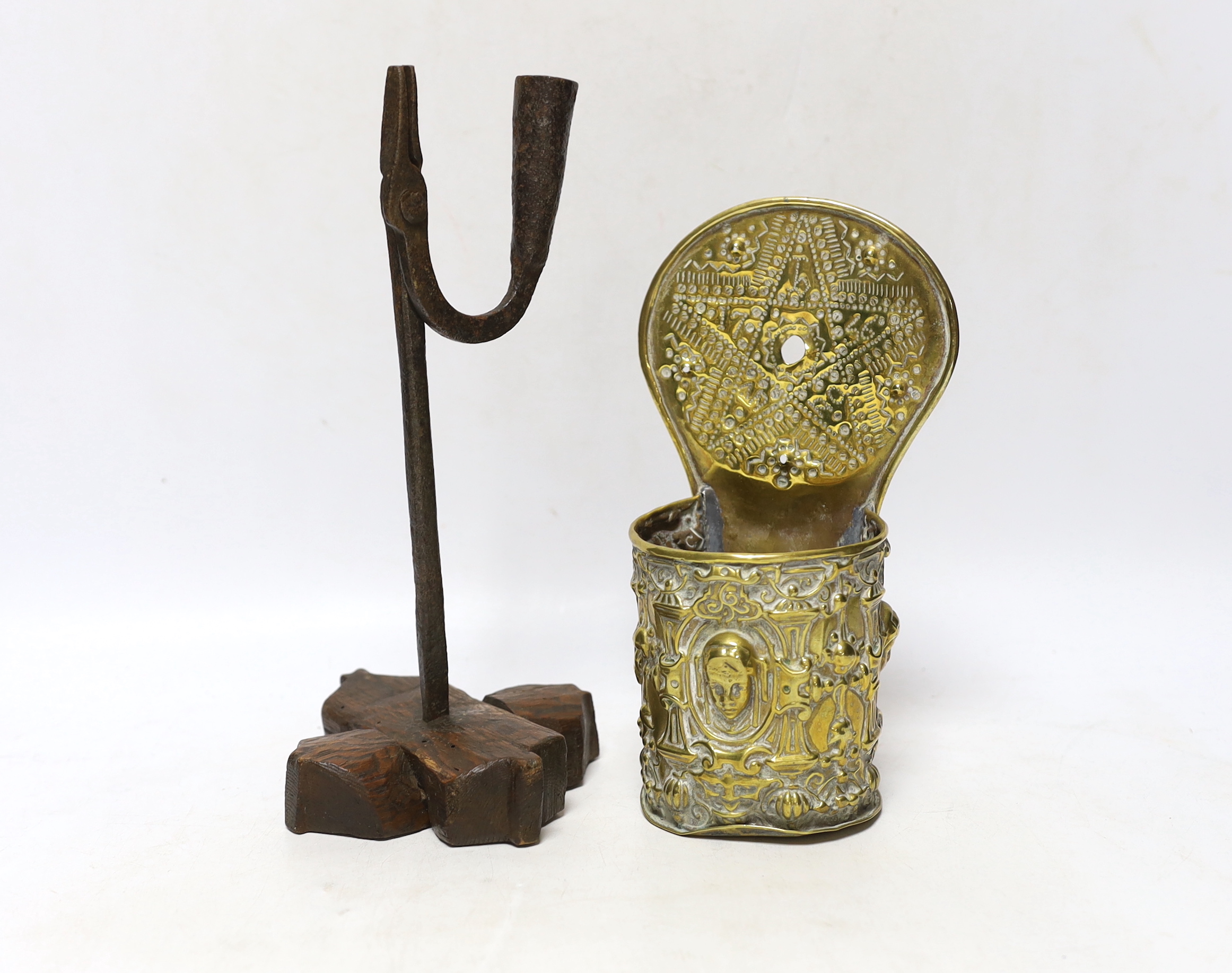 A brass flint box or holy water stoop together with a wrought iron taperstick